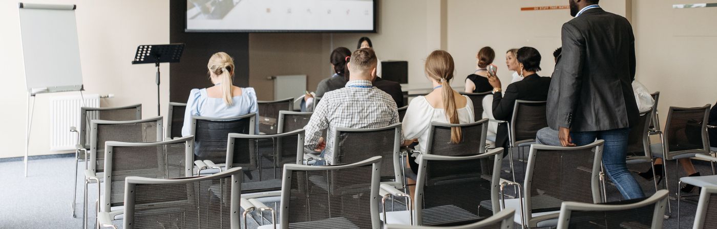 Staff and volunteers seated for a safety training session in an ordinary meeting room